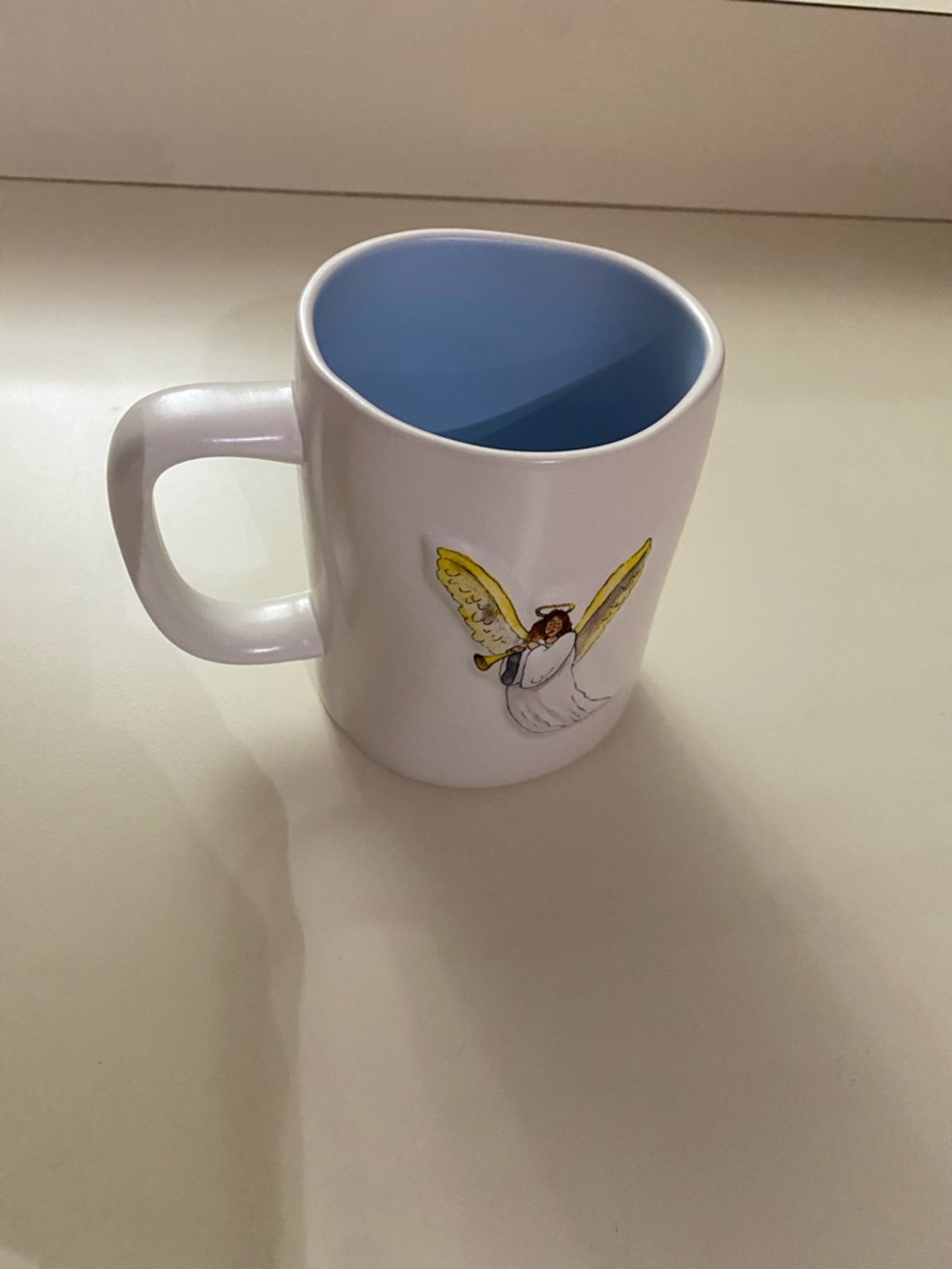 Rae Dunn White Ceramic Mug with Yellow Angel and Blue Interior
